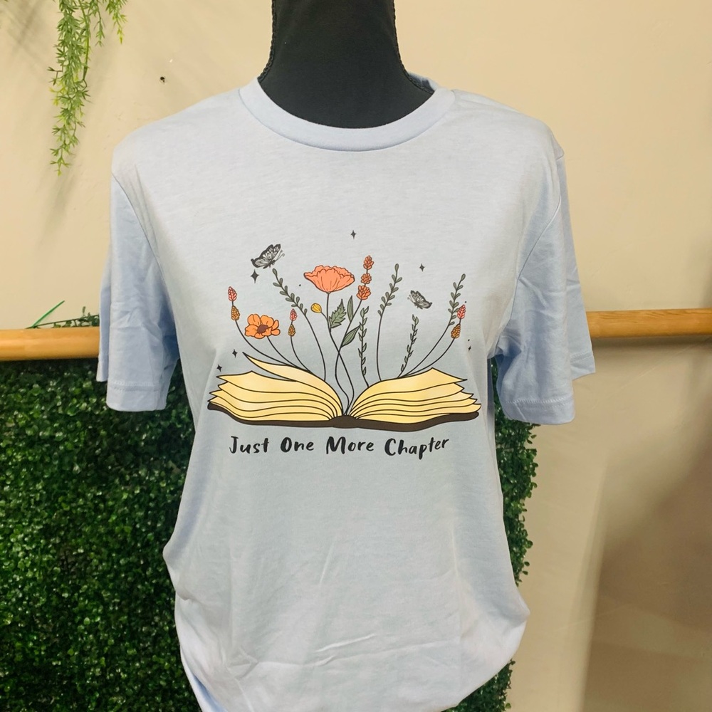 NWOT Light Blue Graphic Tee with Floral Book Design